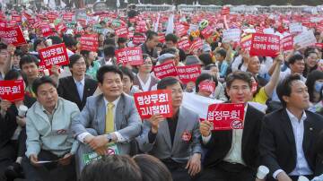 Korean citizens protesting in the 2000s against US beef imports, which could be infected with mad cow disease. Japan had already banned US imports. Picture via Shutterstock.