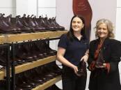 Leather apprentice (left) with Tattarang director Nicola Forrest. icture from RM Williams.
