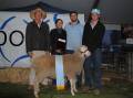 John, Robyn, James and Peter Nadin, Macquarie Dohne stud, Ballimore, NSW, with their supreme champion Dohne ewe and the trophy in memory of their late son and brother, Tom. Picture by Barry Murphy 