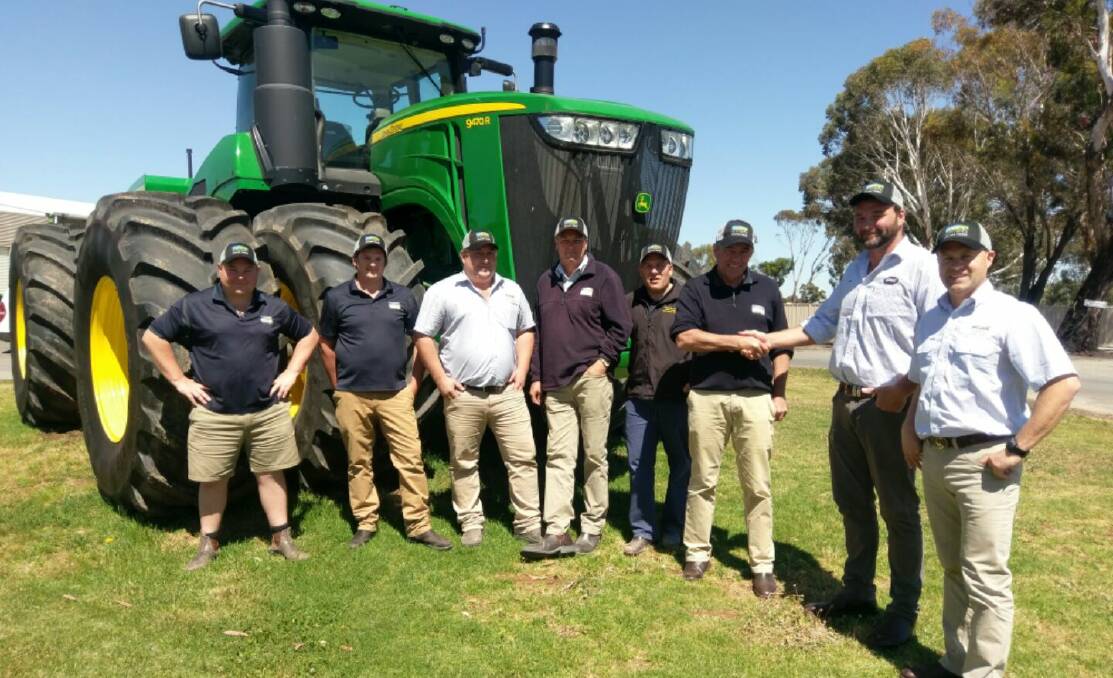 Emmetts Swan Hill sales manager, Rick Austerberry, (L) seals the deal with Gav Wilson of Bourgault as the Emmetts team looks on.