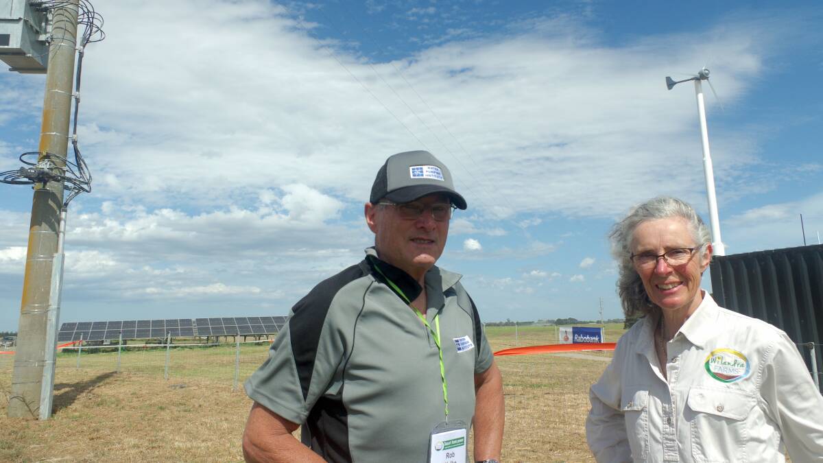Rob Welke with Sandra Jefford on Wilandra Farm, Clydebank, Vic. The solar panels and wind turbines provide renewable energy and a shed has been built to store batteries when the microgrid is a reality. Mr Welke undertook an irrigation energy audit of the dairy farm. Picture by Jeanette Severs 