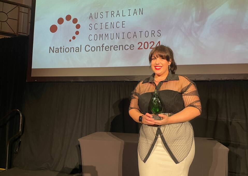 The AusSMC's Olivia Henry accepts the Inspiring Project in Science Communication award at the Australian Science Communicators conference in Perth. Picture supplied