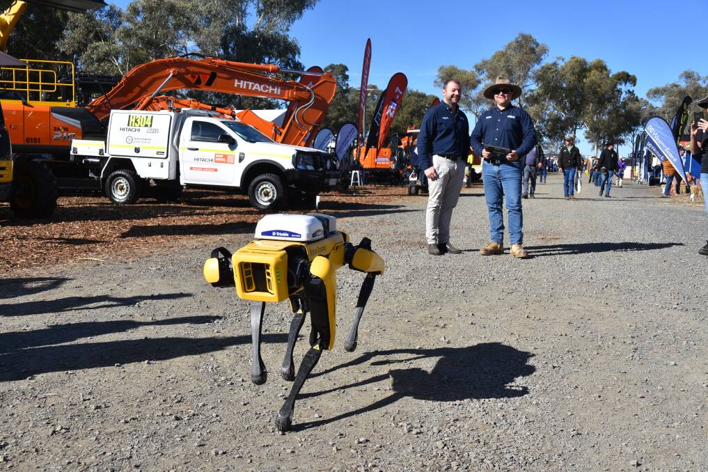 The Boston Dynamics robot dog with Brent Dawson and Matt Wells of SITECH Construction Systems, Brisbane. Picture: Ben Harden 